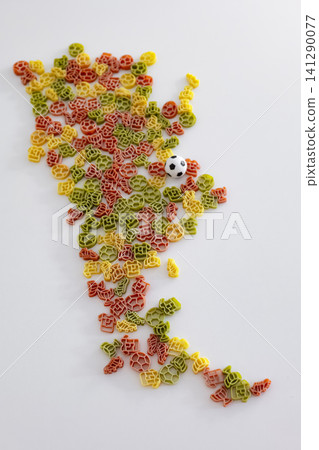 Shape of Argentina arranged with colorful pasta pieces and a small soccer ball, forming a playful tribute to the football culture. 141290077