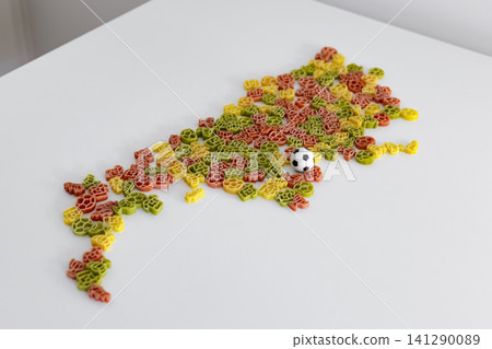 Shape of Argentina arranged with colorful pasta pieces and a small soccer ball, forming a playful tribute to the football culture. Shape of Argentina arranged with colorful pasta pieces and a small soccer ball, forming a playful tribute to the football culture. 141290089