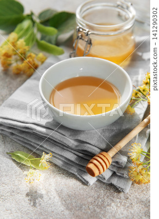 Natural linden blossom honey in bowl and jar Natural linden blossom honey in bowl and jar 141290302