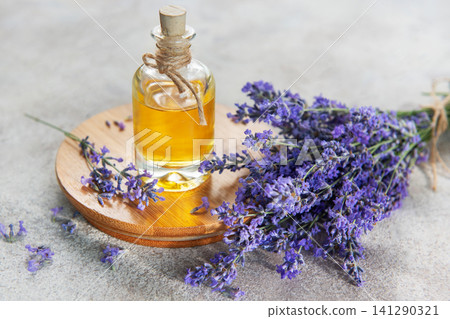 Lavender essential oil bottle with fresh flowers 141290321