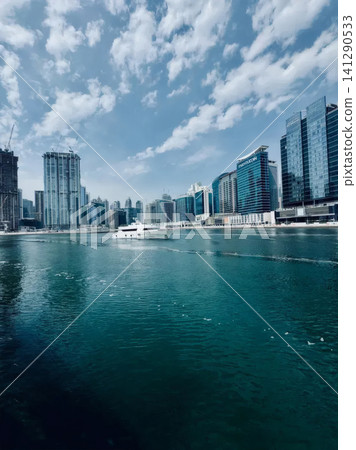 City skyline with modern skyscrapers and boats on water City skyline with modern skyscrapers and boats on water 141290533