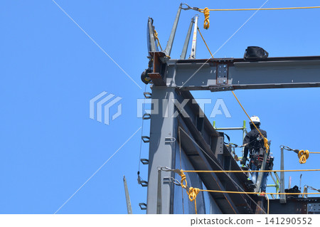 Construction site: Steel frame assembly, scaffolders at work Construction site: Steel frame assembly, scaffolders at work 141290552