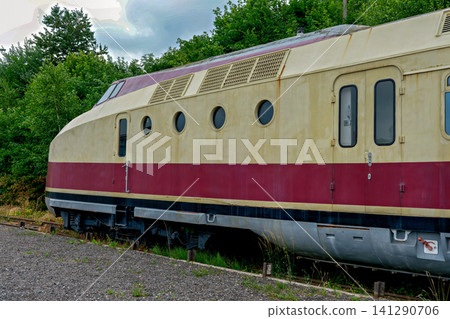Vintage streamlined retro diesel train with round porthole windows on tracks Vintage streamlined retro diesel train with round porthole windows on tracks 141290706