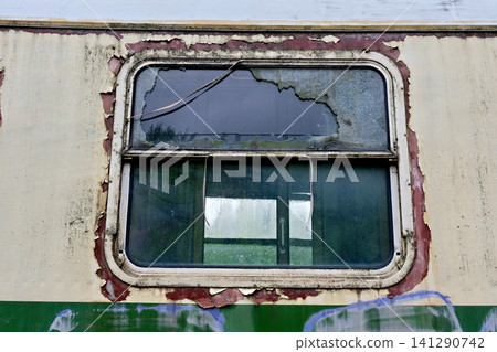 Close up of a broken window with peeling paint on a vintage train 141290742
