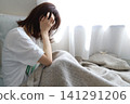 A woman holding a head 141291206