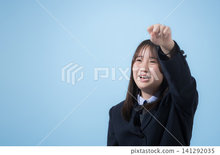 Middle and high school girls in their uniforms stand against a light blue background, smiling and looking at the camera, striking a triumphant pose to convey energy, encouragement, and their determination to pass their exams. Middle and high school girls in their uniforms stand against a light blue background, smiling and looking at the camera, striking a triumphant pose to convey energy, encouragement, and their determination to pass their exams. 141292035