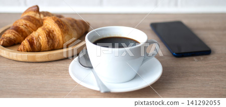 Buttered whole wheat toast with black coffee and smartphone Buttered whole wheat toast with black coffee and smartphone 141292055