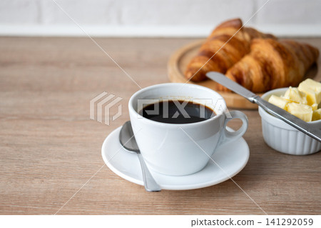Buttered whole wheat toast with black coffee for breakfast Buttered whole wheat toast with black coffee for breakfast 141292059