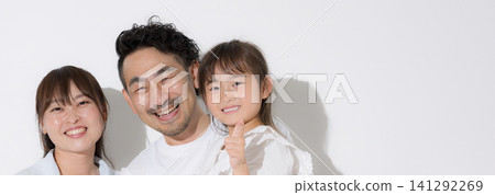 A banner featuring a smiling, close-knit family against a white background, symbolizing a happy family life and healthy living, with a short-sleeved summer vacation image and direct gaze at the camera. A banner featuring a smiling, close-knit family against a white background, symbolizing a happy family life and healthy living, with a short-sleeved summer vacation image and direct gaze at the camera. 141292269