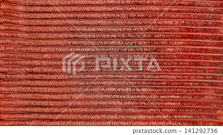 rust corduroy fabric texture background with horizontal ribbed velvet wales close up rust corduroy fabric texture background with horizontal ribbed velvet wales close up 141292736