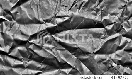 crumpled grey paper texture creating dark dramatic shadow in organic minimalist background crumpled grey paper texture creating dark dramatic shadow in organic minimalist background 141292772