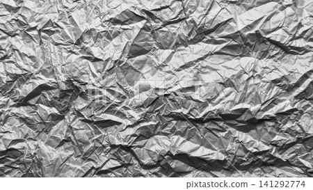 crumpled metallic foil texture forms a dramatic abstract pattern featuring high contrast shadows and silver ridges crumpled metallic foil texture forms a dramatic abstract pattern featuring high contrast shadows and silver ridges 141292774