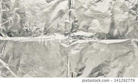 crumpled silver aluminum foil background texture shows metallic crinkled surface reflecting soft industrial ambient light crumpled silver aluminum foil background texture shows metallic crinkled surface reflecting soft industrial ambient light 141292779