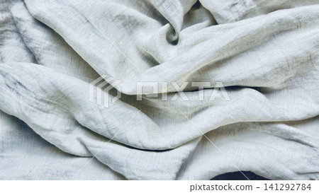 natural linen fabric texture background with elegant organic folds in soft overhead light creates a serene minimalist mood natural linen fabric texture background with elegant organic folds in soft overhead light creates a serene minimalist mood 141292784