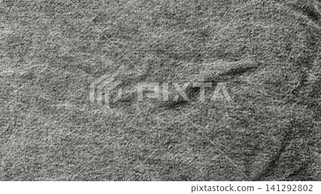 black denim fabric texture creates organic creases in a minimalist monochrome background highlighting textile weave detail black denim fabric texture creates organic creases in a minimalist monochrome background highlighting textile weave detail 141292802