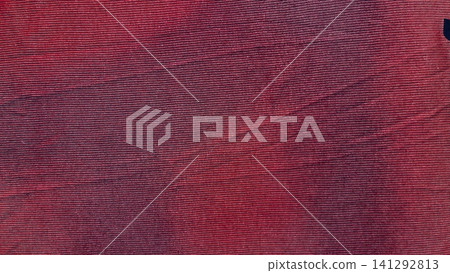 crimson corduroy fabric texture shows organic ribbed lines in a minimalist flat lay macro close up creating a cozy mood crimson corduroy fabric texture shows organic ribbed lines in a minimalist flat lay macro close up creating a cozy mood 141292813