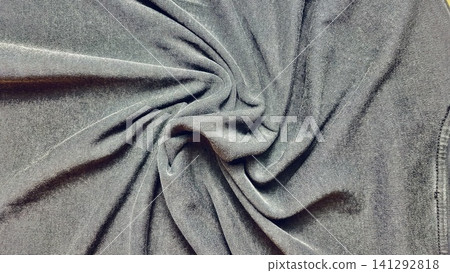 charcoal black jersey fabric swirled into a dynamic spiral pattern creating an elegant organic texture background charcoal black jersey fabric swirled into a dynamic spiral pattern creating an elegant organic texture background 141292818