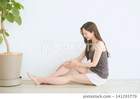 A young woman doing skincare on her legs at home A young woman doing skincare on her legs at home 141293779