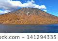 The magnificent view of Lake Chuzenji's blue surface and the majestic Mount Nantai ablaze with autumn colors. The magnificent view of Lake Chuzenji's blue surface and the majestic Mount Nantai ablaze with autumn colors. 141294335