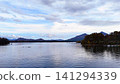 The tranquil shores of Lake Akimoto and the breathtaking view of the distant mountains. The tranquil shores of Lake Akimoto and the breathtaking view of the distant mountains. 141294339
