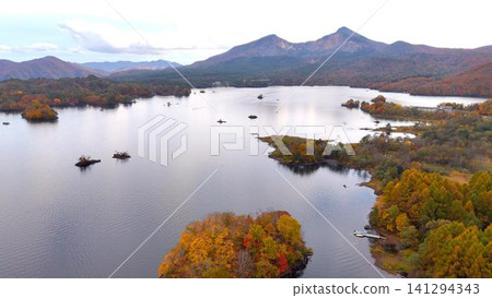 Mount Bandai, a symbol of Ura-Bandai, and the vibrant autumn foliage of Lake Akimoto Mount Bandai, a symbol of Ura-Bandai, and the vibrant autumn foliage of Lake Akimoto 141294343