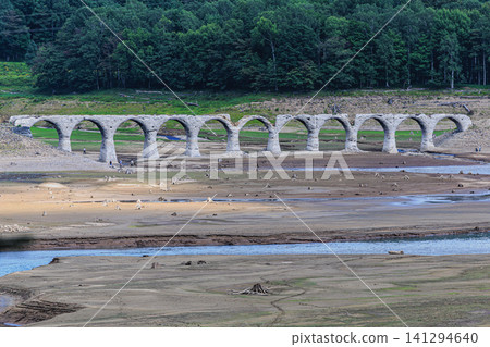 A vast lakebed dotted with tree stumps and the nostalgic abandoned railway line of the former JNR Shihoro Line. A vast lakebed dotted with tree stumps and the nostalgic abandoned railway line of the former JNR Shihoro Line. 141294640