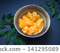 Two types of fresh sea urchin from Hokkaido served in small bowls. 141295089