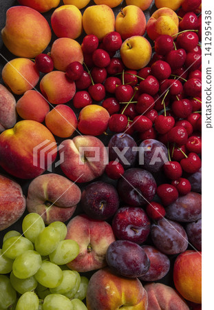 Colorful fresh stone fruit and green grapes assortment Colorful fresh stone fruit and green grapes assortment 141295438