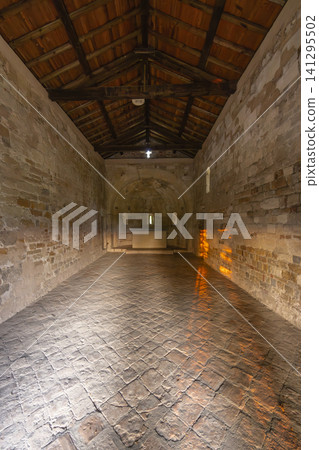Ancient Romanesque chapel displaying stone walls and wooden roof Ancient Romanesque chapel displaying stone walls and wooden roof 141295502