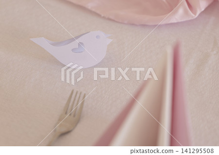 Romantic table setting with paper bird and pink accents Romantic table setting with paper bird and pink accents 141295508