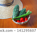 Fresh summer vegetables harvested from the home garden and a straw hat 141295607