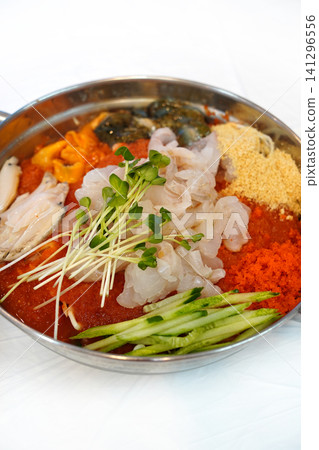 Korean cold raw fish soup Mulhoe with fresh seafood and spicy broth Korean cold raw fish soup Mulhoe with fresh seafood and spicy broth 141296556