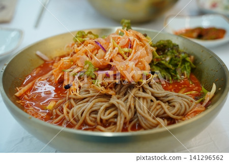 Korean cold raw fish soup Mulhoe with fresh seafood and spicy broth Korean cold raw fish soup Mulhoe with fresh seafood and spicy broth 141296562