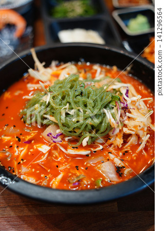 Korean cold raw fish soup Mulhoe with fresh seafood and spicy broth Korean cold raw fish soup Mulhoe with fresh seafood and spicy broth 141296564