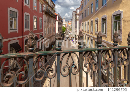 View of a historic street lined with traditional buildings from a pedestrian bridge in central Lisbon, Portugal. View of a historic street lined with traditional buildings from a pedestrian bridge in central Lisbon, Portugal. 141296793