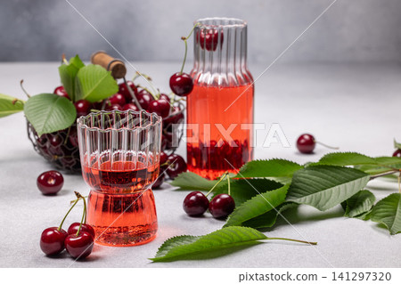 Fresh cherry juice drink in ribbed glasses Fresh cherry juice drink in ribbed glasses 141297320