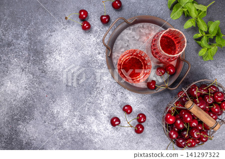 Cherry drink and fresh ripe cherries on rustic background Cherry drink and fresh ripe cherries on rustic background 141297322