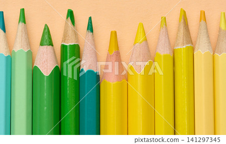 Multicolored wooden pencils in a row, drawing and creativity tools 141297345