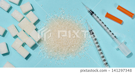 Different types of sugar and medical syringes on a blue background, the problem of diabetes and glucose control in the body. Different types of sugar and medical syringes on a blue background, the problem of diabetes and glucose control in the body. 141297348