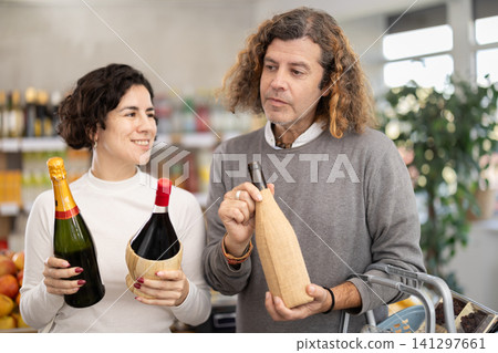 couple chooses wine and champagne couple chooses wine and champagne 141297661
