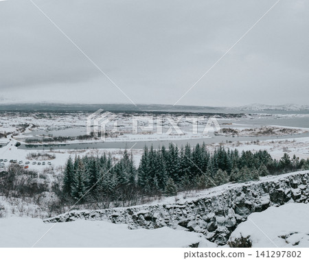 Snowy winter landscape of Thingvellir National Park, Iceland, with lakes and forests. Snowy winter landscape of Thingvellir National Park, Iceland, with lakes and forests. 141297802