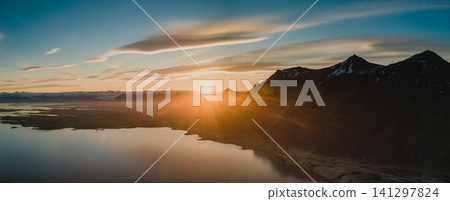 Sunset over Skardsfjordur with dramatic mountain silhouettes, South Iceland. Sunset over Skardsfjordur with dramatic mountain silhouettes, South Iceland. 141297824