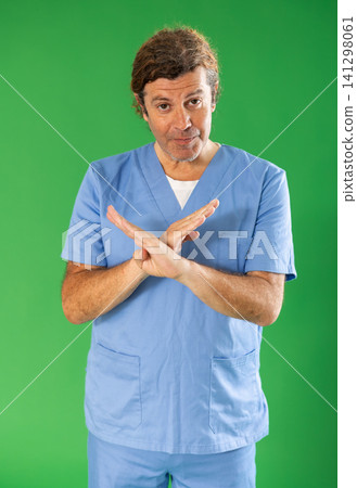 Adult male medic explaining medical information on green screen 141298061