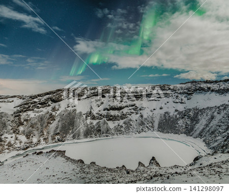 Northern lights above the snow-covered Kerid Crater and frozen lake in south Iceland Northern lights above the snow-covered Kerid Crater and frozen lake in south Iceland 141298097