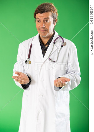 Adult male medic explaining medical information on green screen Adult male medic explaining medical information on green screen 141298144