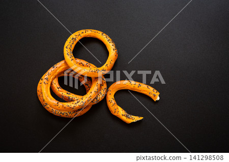 Traditional bread bagels arranged on dark wooden background Traditional bread bagels arranged on dark wooden background 141298508