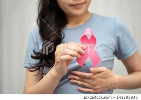 Asian woman with pink ribbon, World Breast Cancer Day at October. 141298930