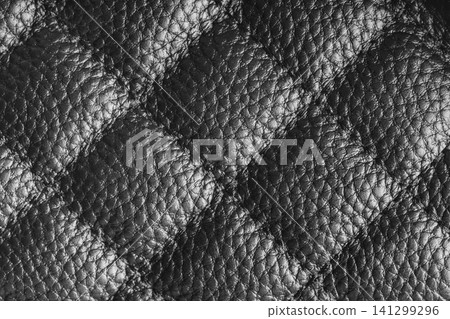 Macro of gray quilted leather texture background with stitched pattern and shining metal effect Macro of gray quilted leather texture background with stitched pattern and shining metal effect 141299296