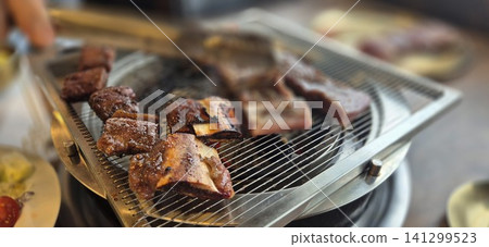 Delicious Marinated Korean Beef Short Ribs Grilling on Charcoal Barbecue Delicious Marinated Korean Beef Short Ribs Grilling on Charcoal Barbecue 141299523