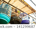 An old bird cage and bird are sold at an Asian market. 141299687